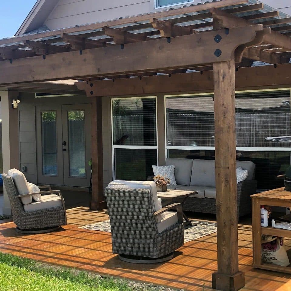 Acid-stained patio under a cedar pergola with outdoor lounge furniture