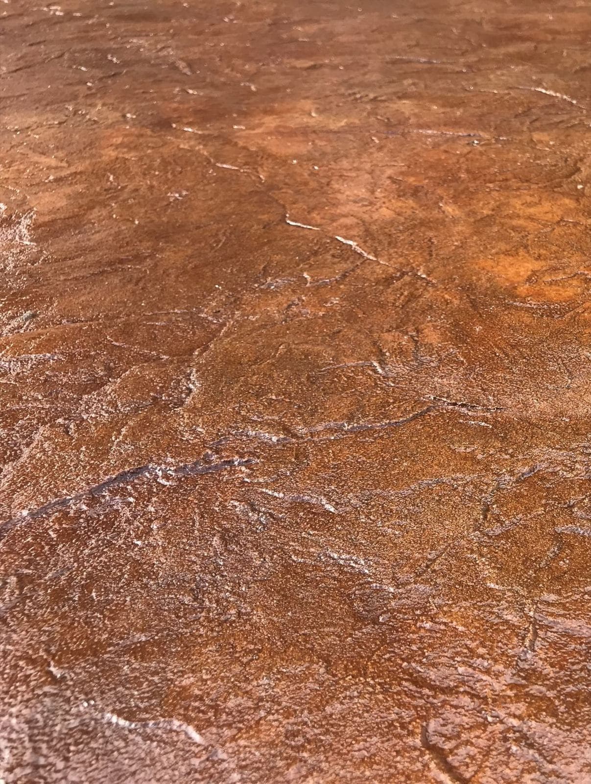Close-up of acid stain texture in browns and golds