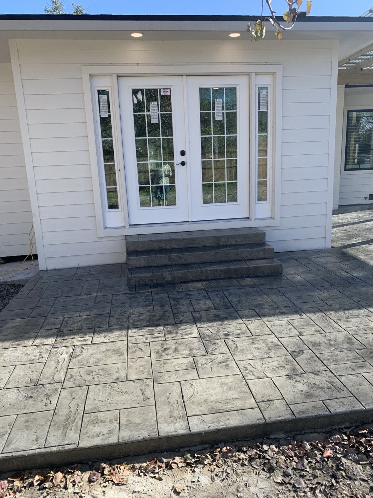 Stamped concrete patio and steps at a back entry