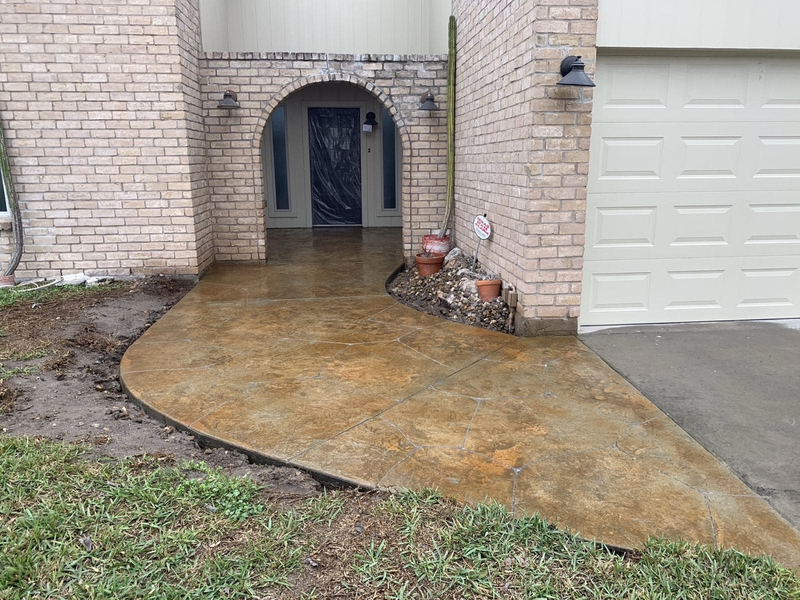 Stained and stamped overlay on a driveway approach and front entry