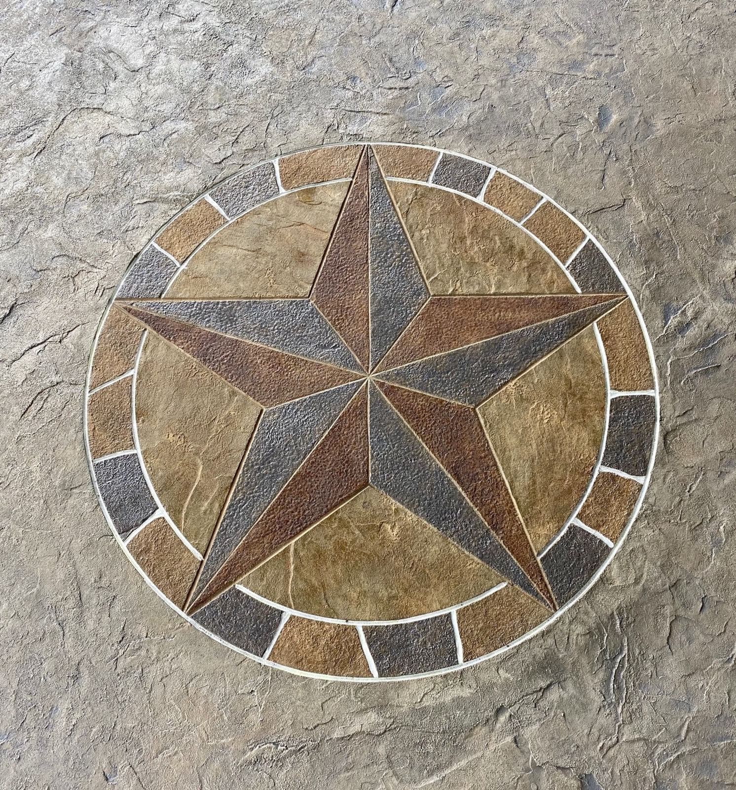Stamped and stained Texas star medallion set into a concrete patio